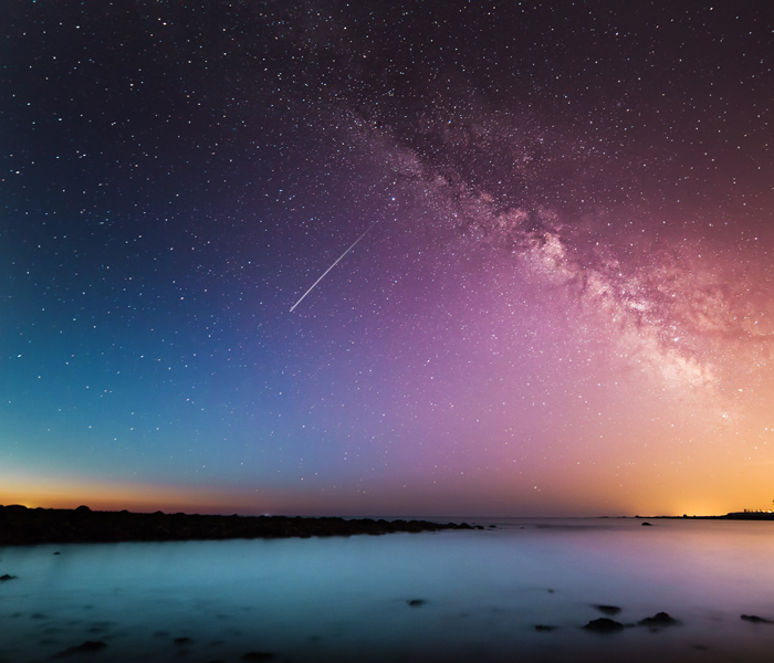 An asteroid falling through the night sky