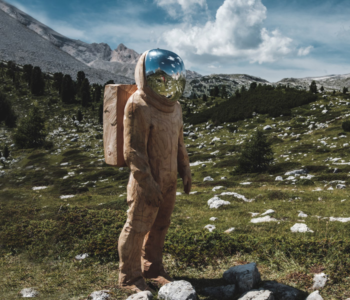 An astronaut sculpture in beautiful nature