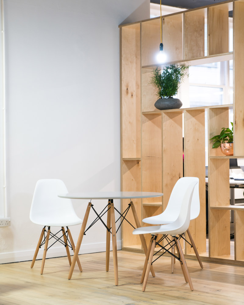 Chair up chairs around a small, round table in an office