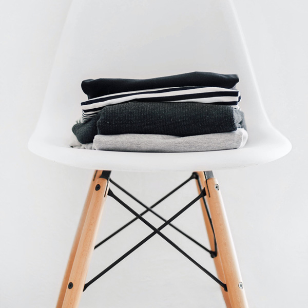 A Chair up chair with neatly folded laundry